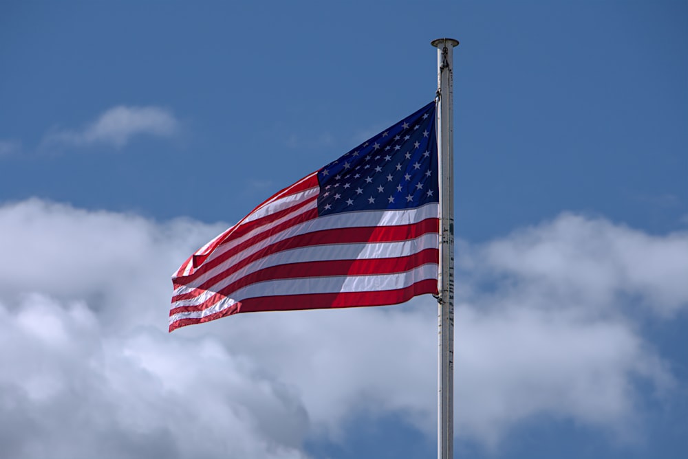 us a flag on pole under blue sky during daytime