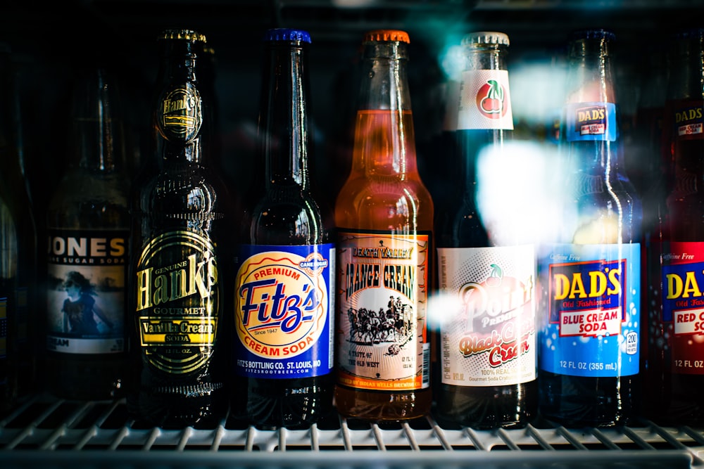 three brown glass bottles on white metal rack