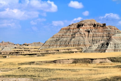 brown and gray rock formation under blue sky during daytime layered teams background