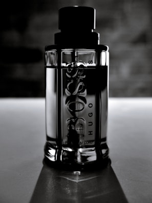 Sacáis bottle placed on a sleek black marble surface with subtle reflections enhancing its glamor.