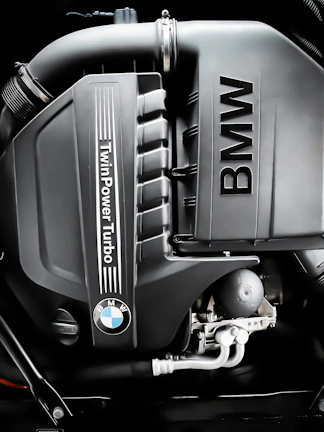 Close-up of a BMW engine receiving detailed maintenance at a modern service garage.