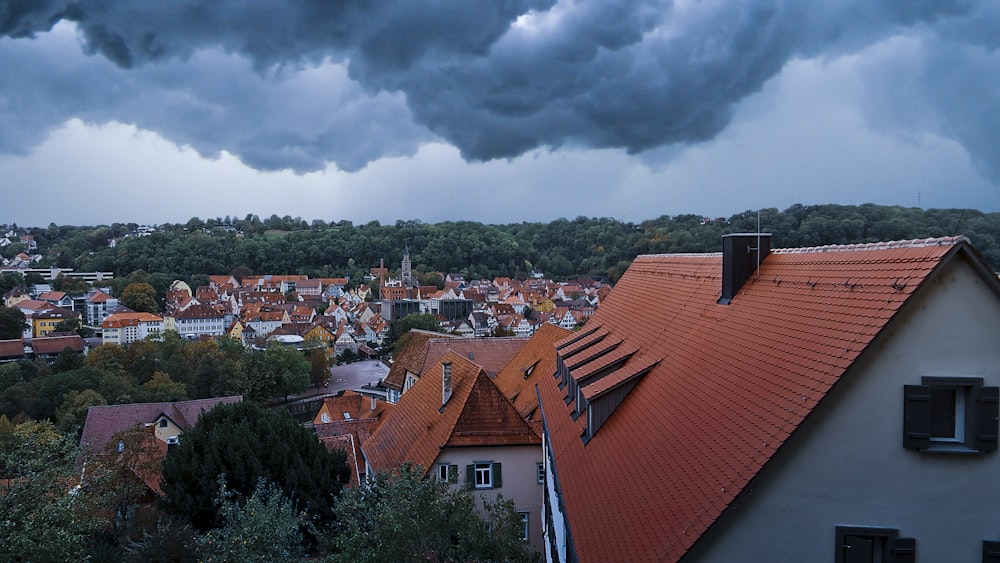 brown and white concrete houses under white clouds during daytime