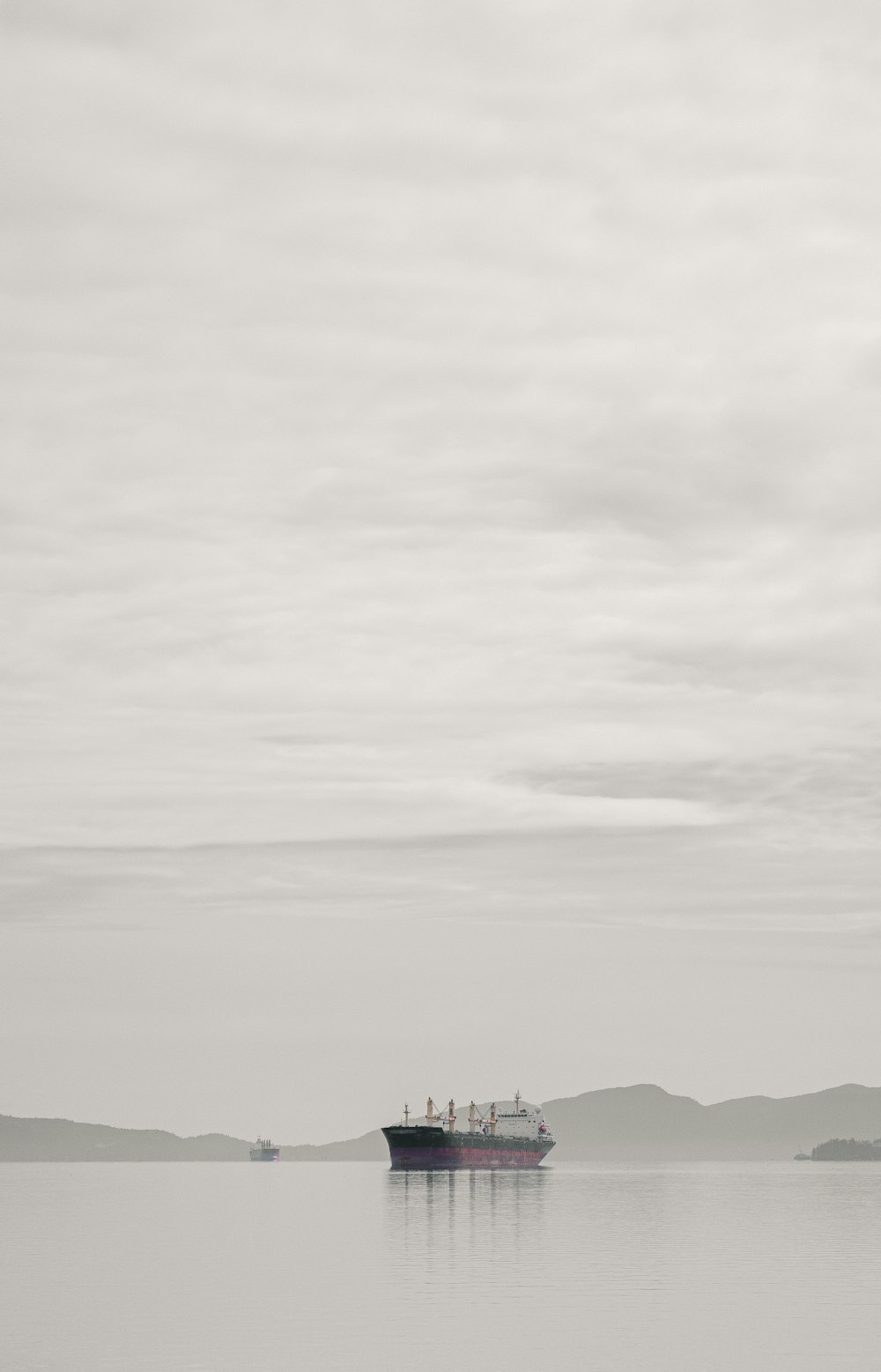 silhouette of mountain under cloudy sky during daytime