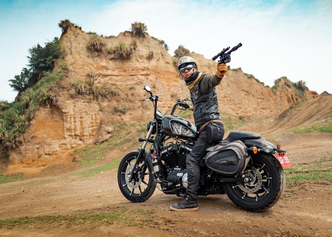 man in black leather jacket riding black motorcycle during daytime