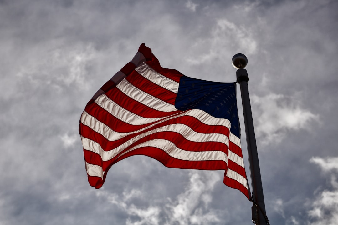 us a flag under cloudy sky during daytime