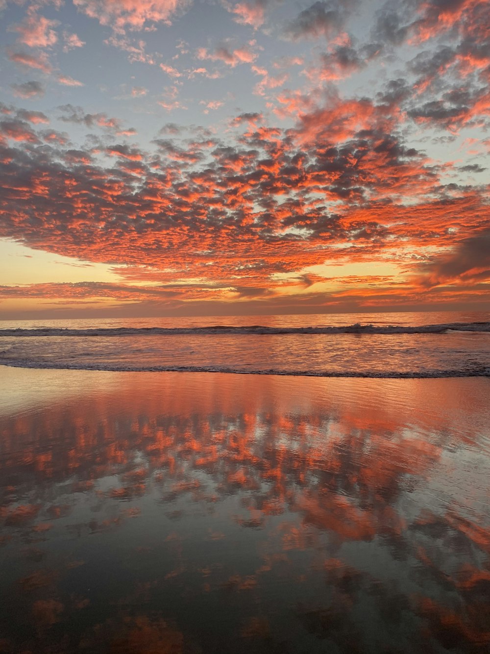 body of water under cloudy sky during sunset