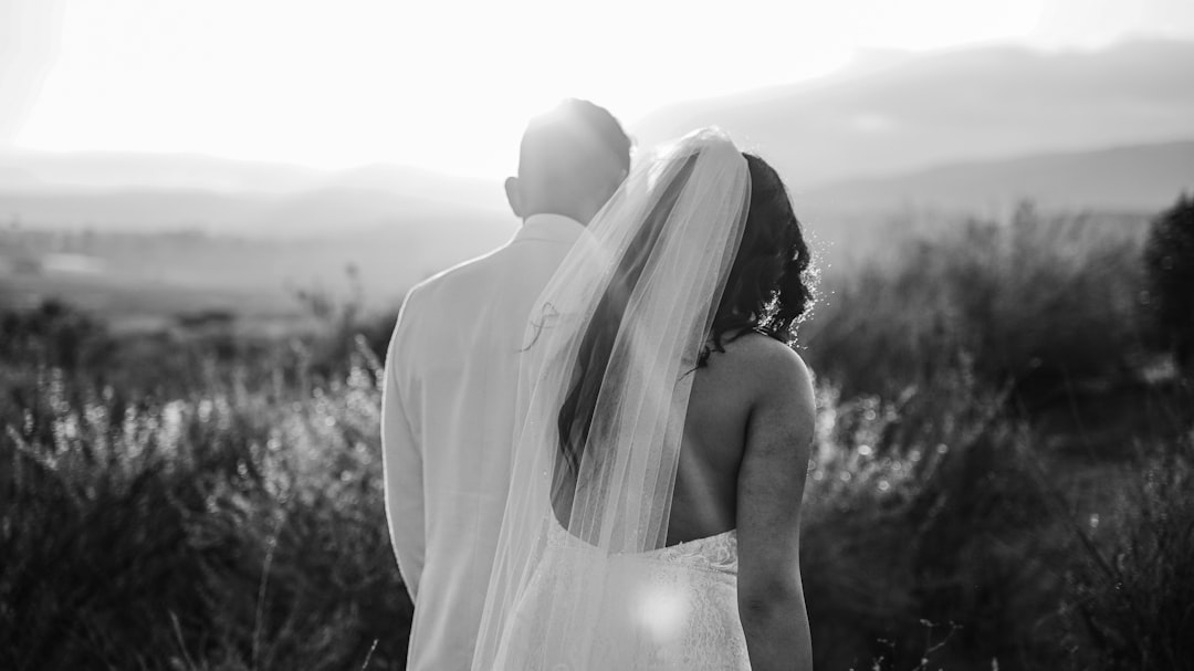 grayscale photo of couple kissing