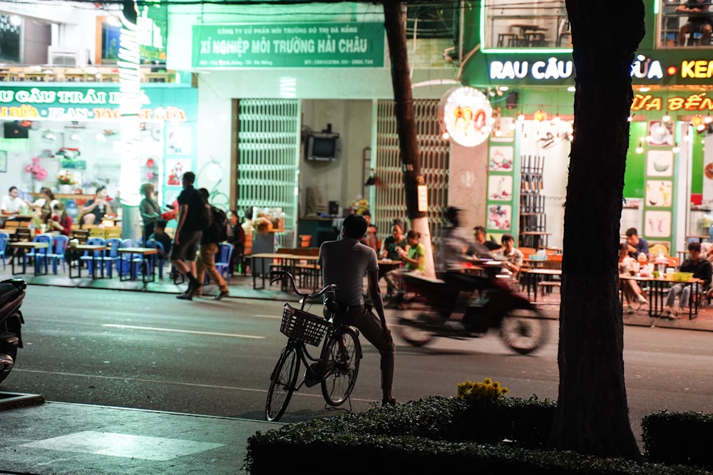 man in black jacket riding on black bicycle during daytime