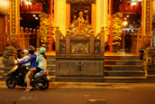 Happy tourists gearing up on scooters near Jagannath Temple, smiling and ready to ride.