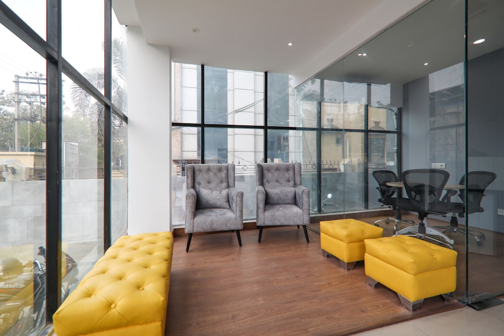 yellow sofa near glass window