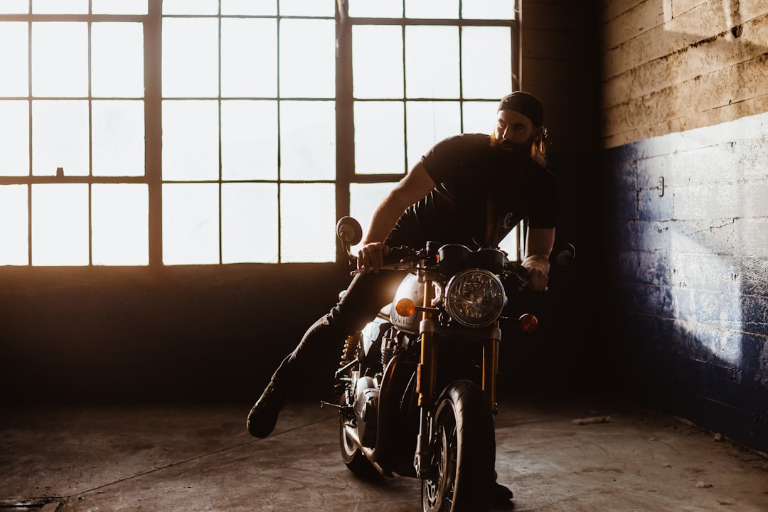 man in black shirt riding motorcycle