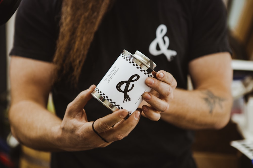 person holding white and black card