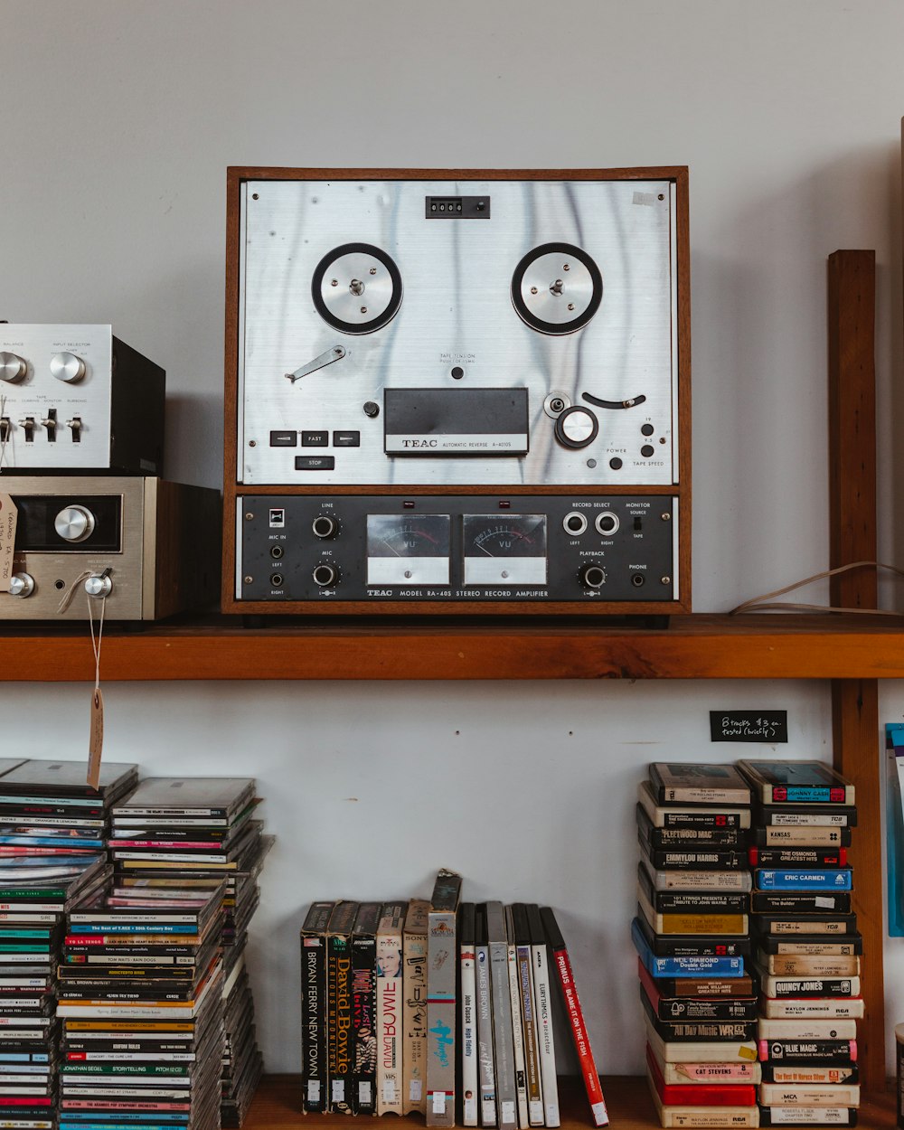 gray and black audio component on brown wooden shelf