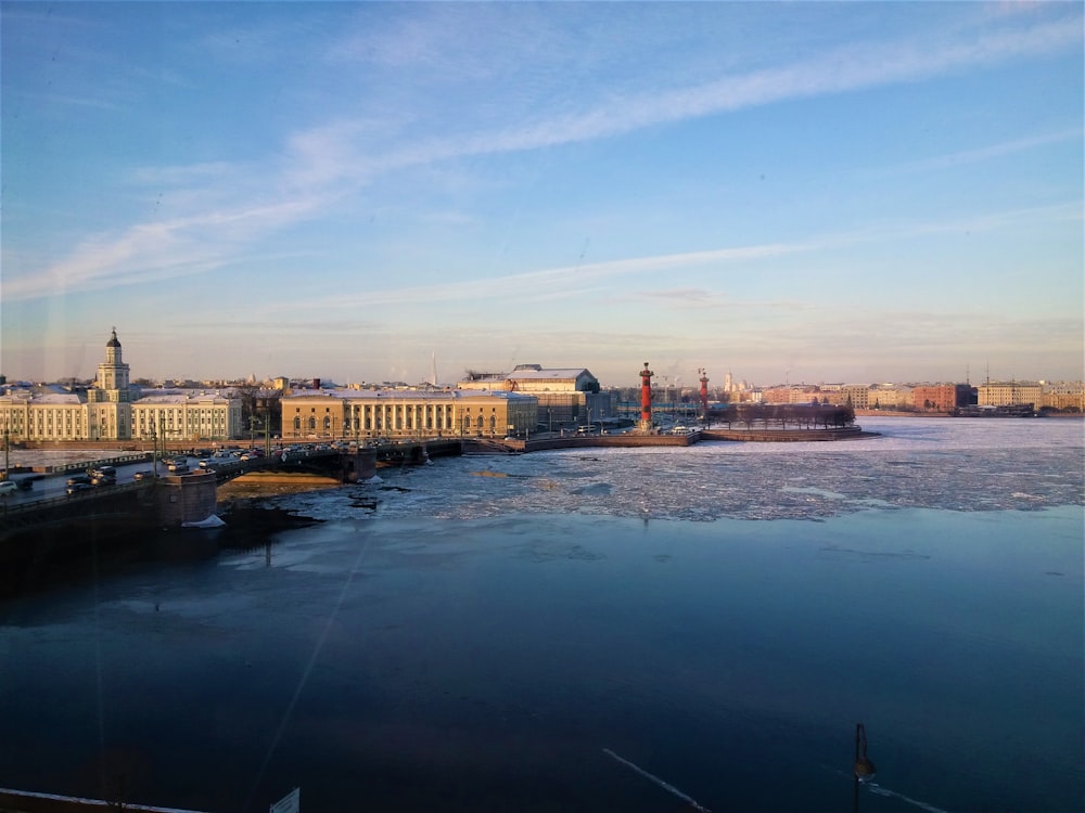 brown concrete bridge over river under blue sky during daytime