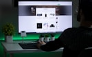 person in black sweater using computer