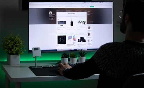 person in black sweater designing websites on a computer