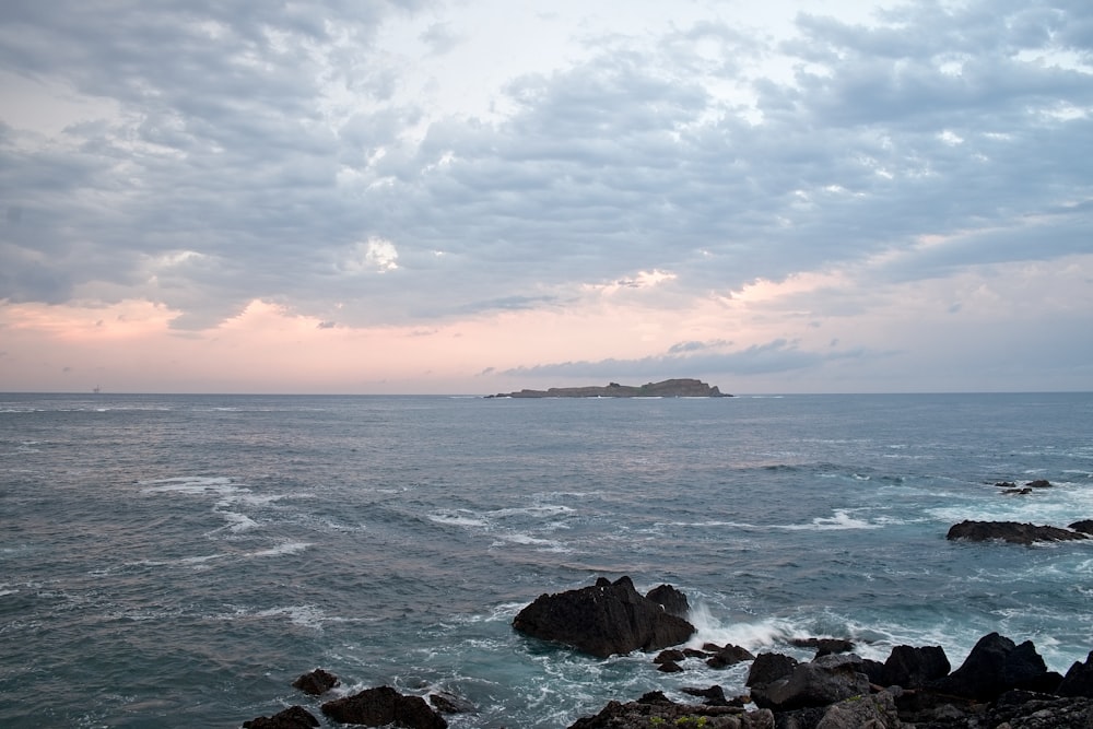 ocean waves crashing on rocks during sunset