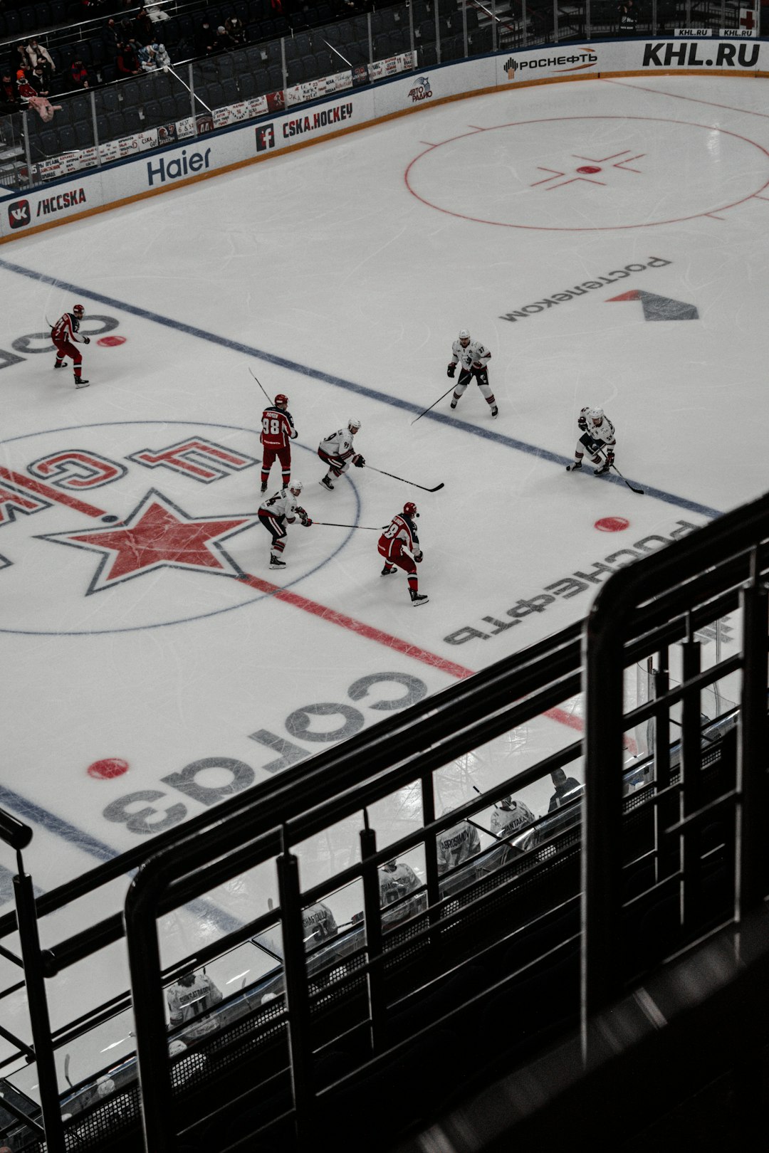 people playing ice hockey on white and red ice hockey field