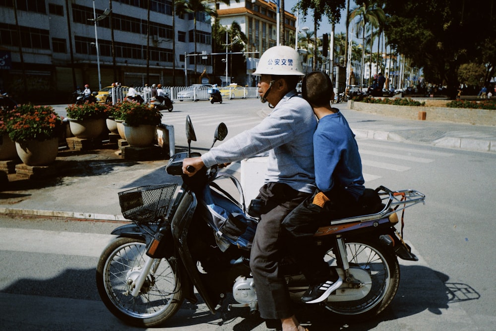 man in blue jacket riding black motorcycle during daytime