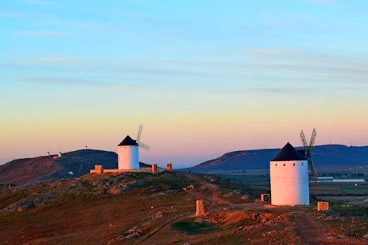 white concrete building on top of hill
