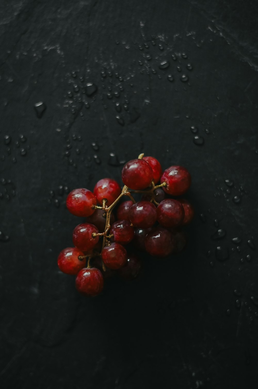 red round fruits on black surface