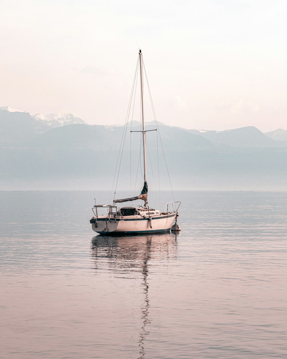 white and blue boat on sea during daytime