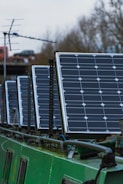 blue solar panels on green metal frame