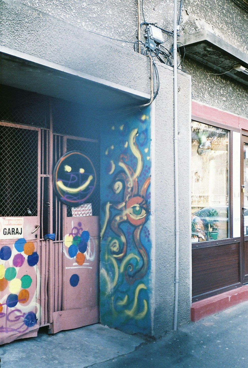 blue and yellow graffiti on wall