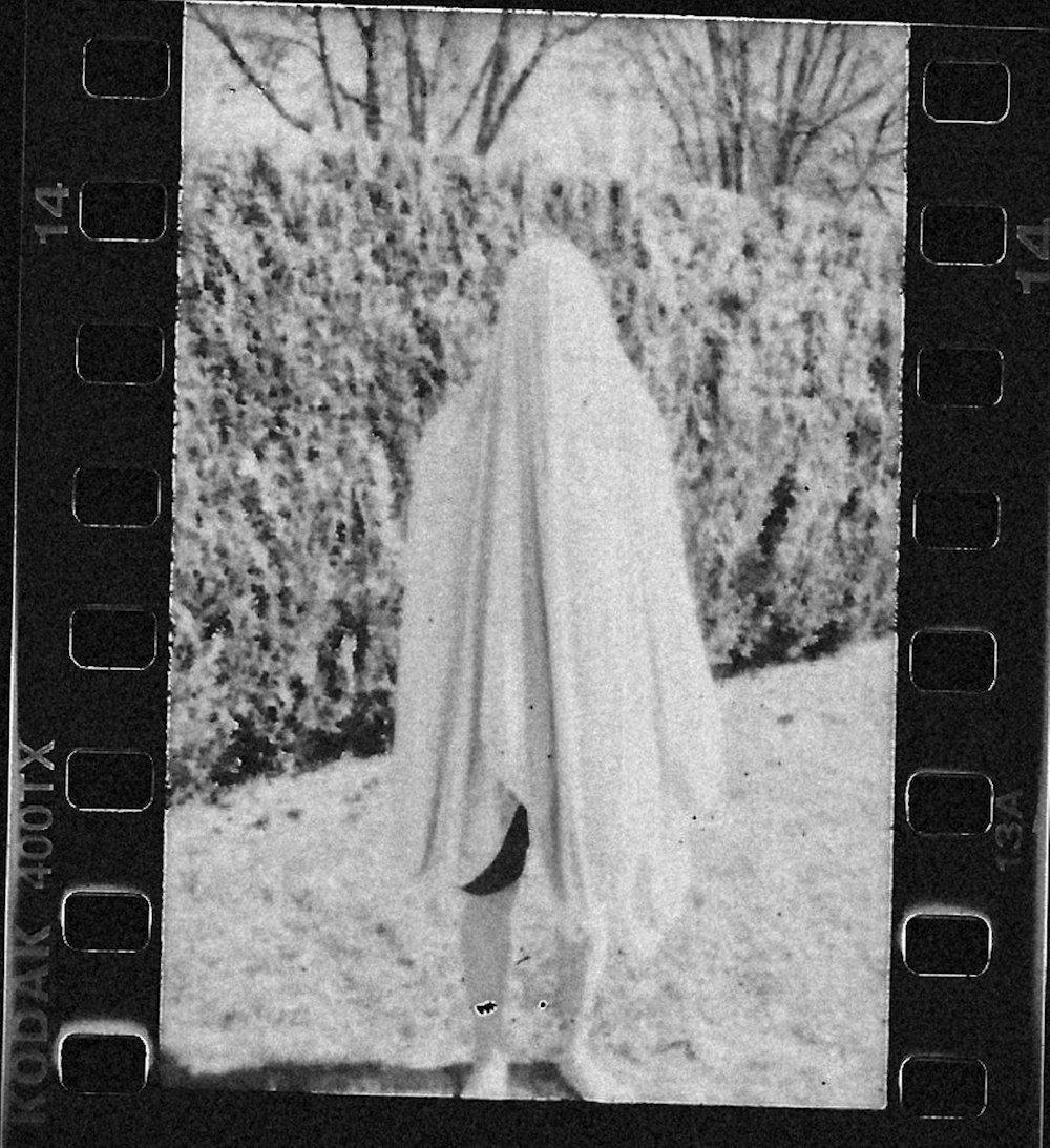 woman in white dress standing on snow covered ground