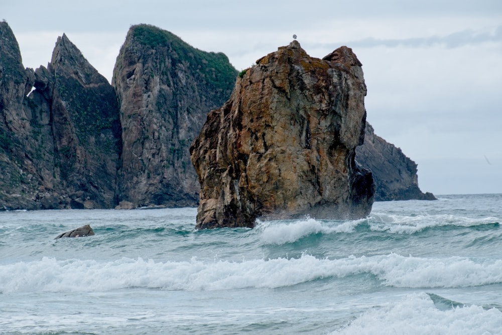 brown rock formation on sea during daytime