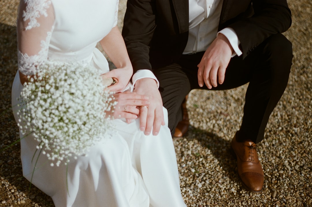 man in black suit jacket and woman in white dress