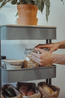 A woman organizing shelves in a neat pantry.
