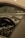 The interior of a luxury car is shown, focusing on the dashboard and central gauge cluster. The steering wheel features a detailed emblem, and the design is sleek and modern with high-quality materials.