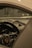 The interior of a luxury car is shown, focusing on the dashboard and central gauge cluster. The steering wheel features a detailed emblem, and the design is sleek and modern with high-quality materials.
