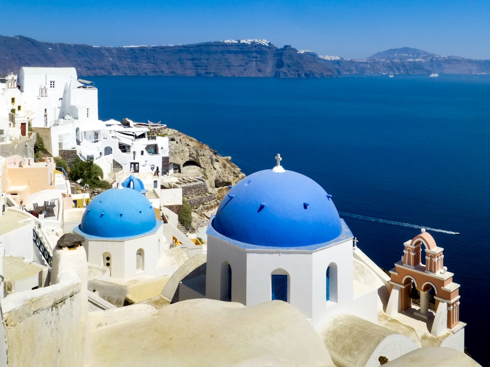 white and blue dome building near body of water during daytime