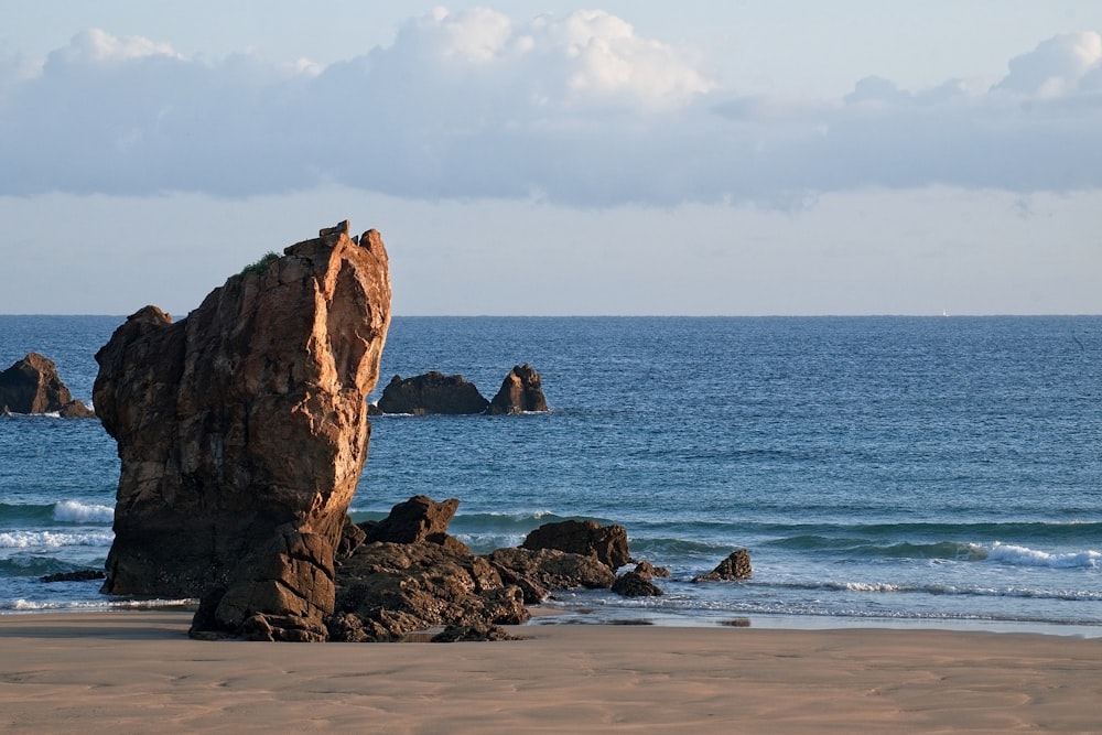 brown rock formation on sea shore during daytime