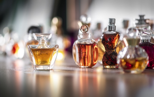 selective focus photography of clear glass perfume bottle