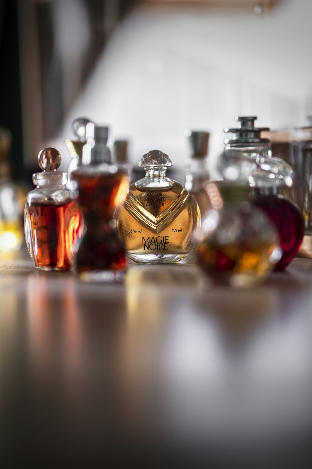 clear glass perfume bottle on table