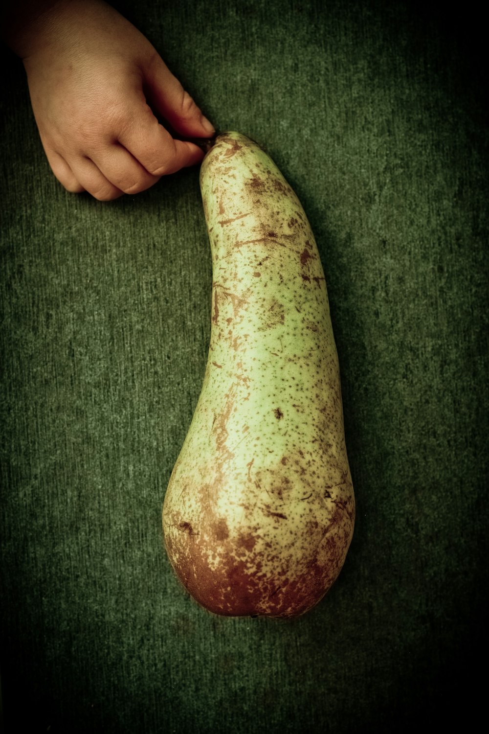 brown and green fruit on green textile