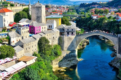 white and brown concrete building near body of water during daytime