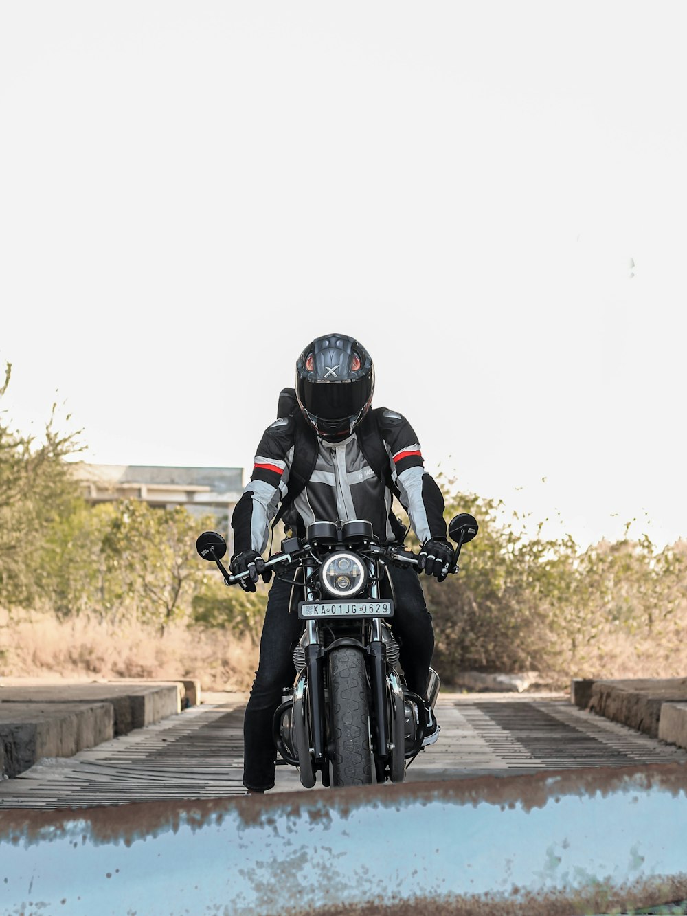 man in black helmet riding black motorcycle on road during daytime