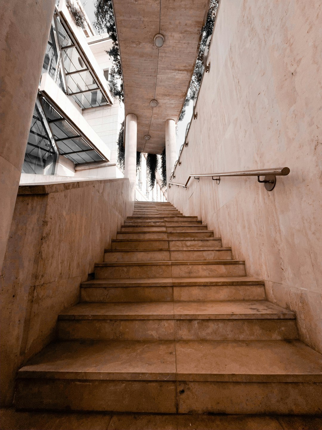 white concrete staircase with white metal railings