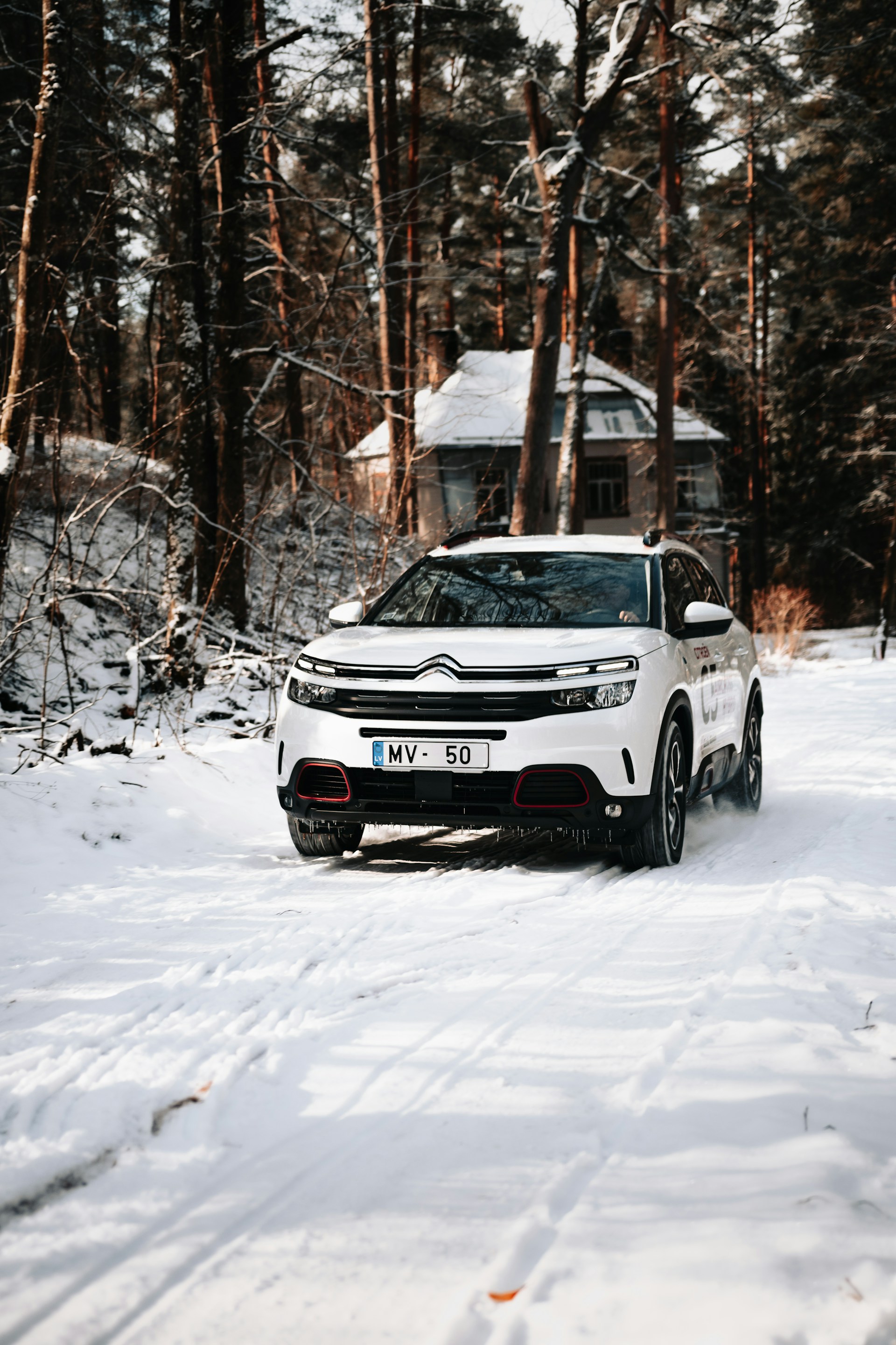 white and black jeep grand cherokee on snow covered ground during daytime