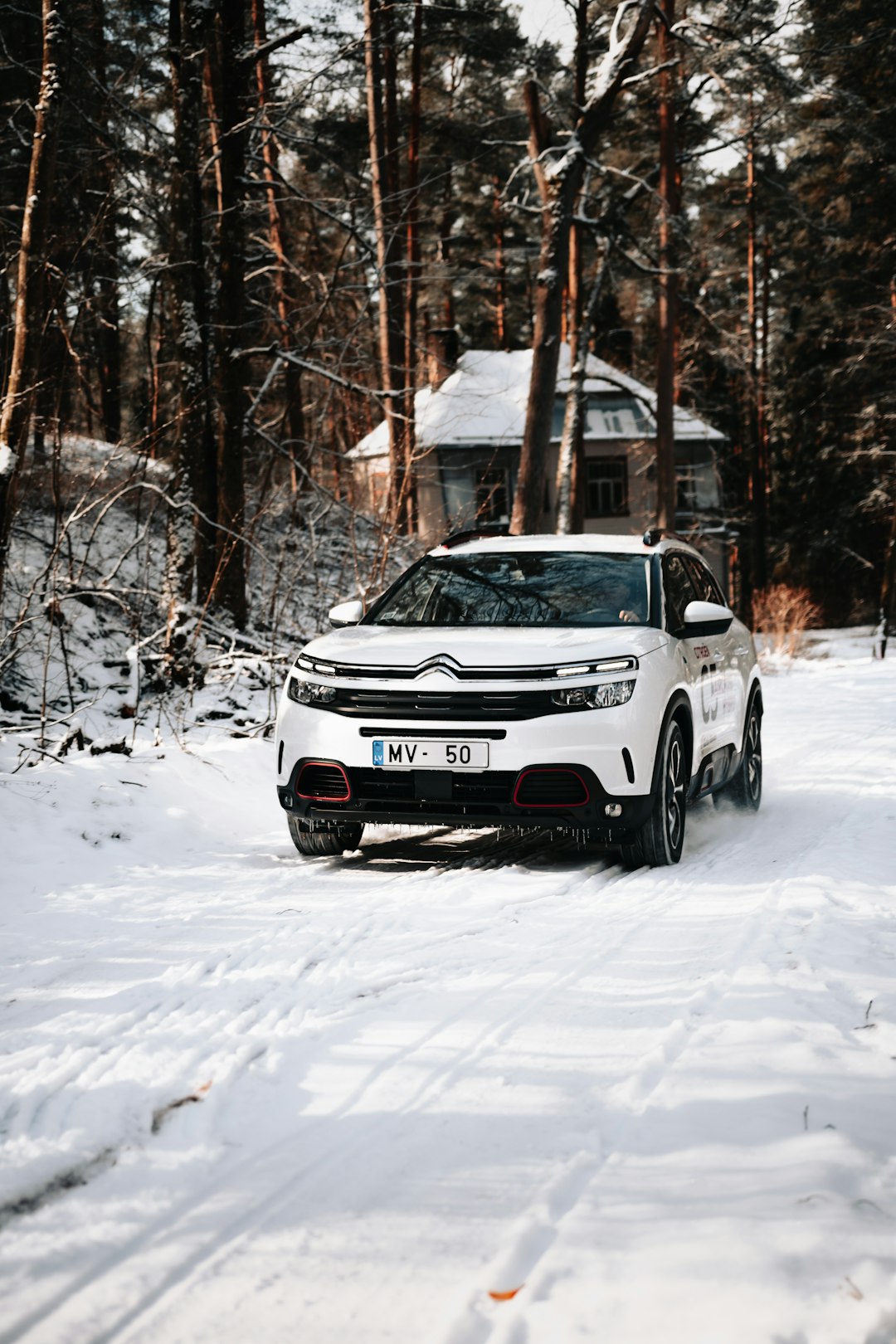 white and black jeep grand cherokee on snow covered ground during daytime