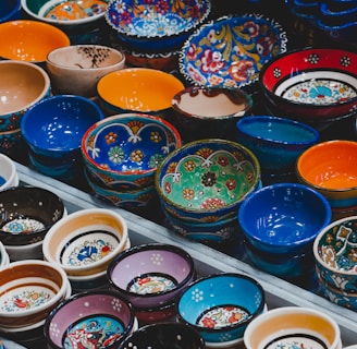 assorted color bowls on white plastic container