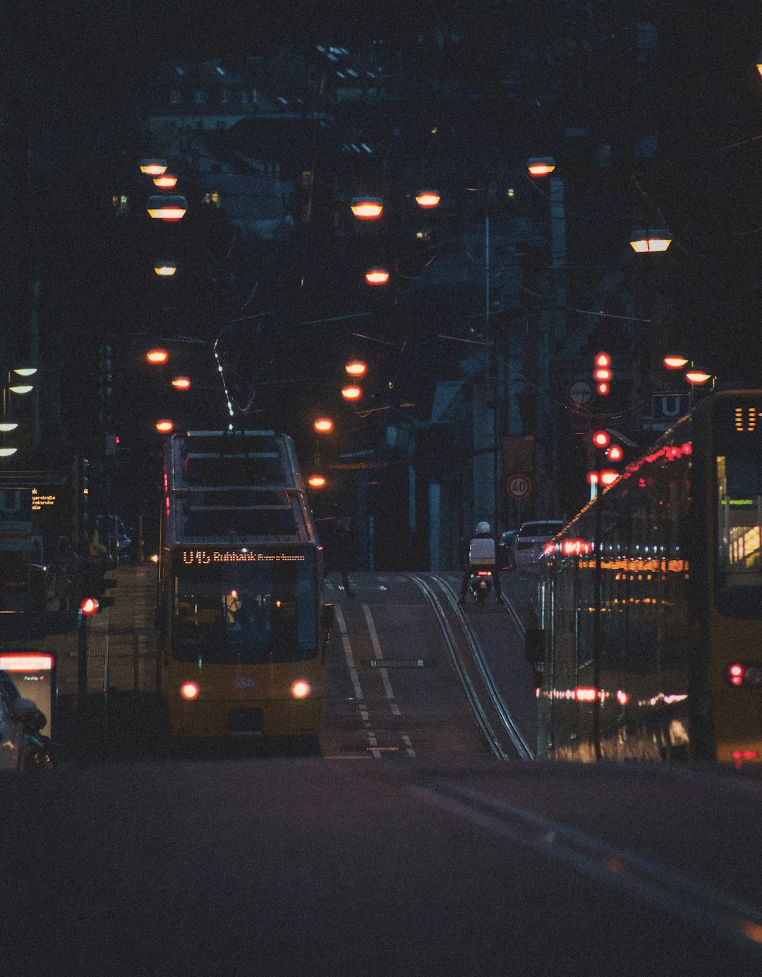 white bus on road during night time