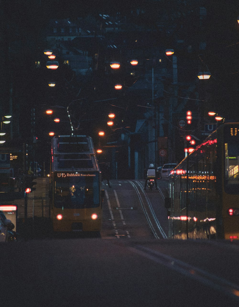 white bus on road during night time