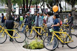 Group of travelers chatting outside a lively hostel with bicycles lined up nearby.