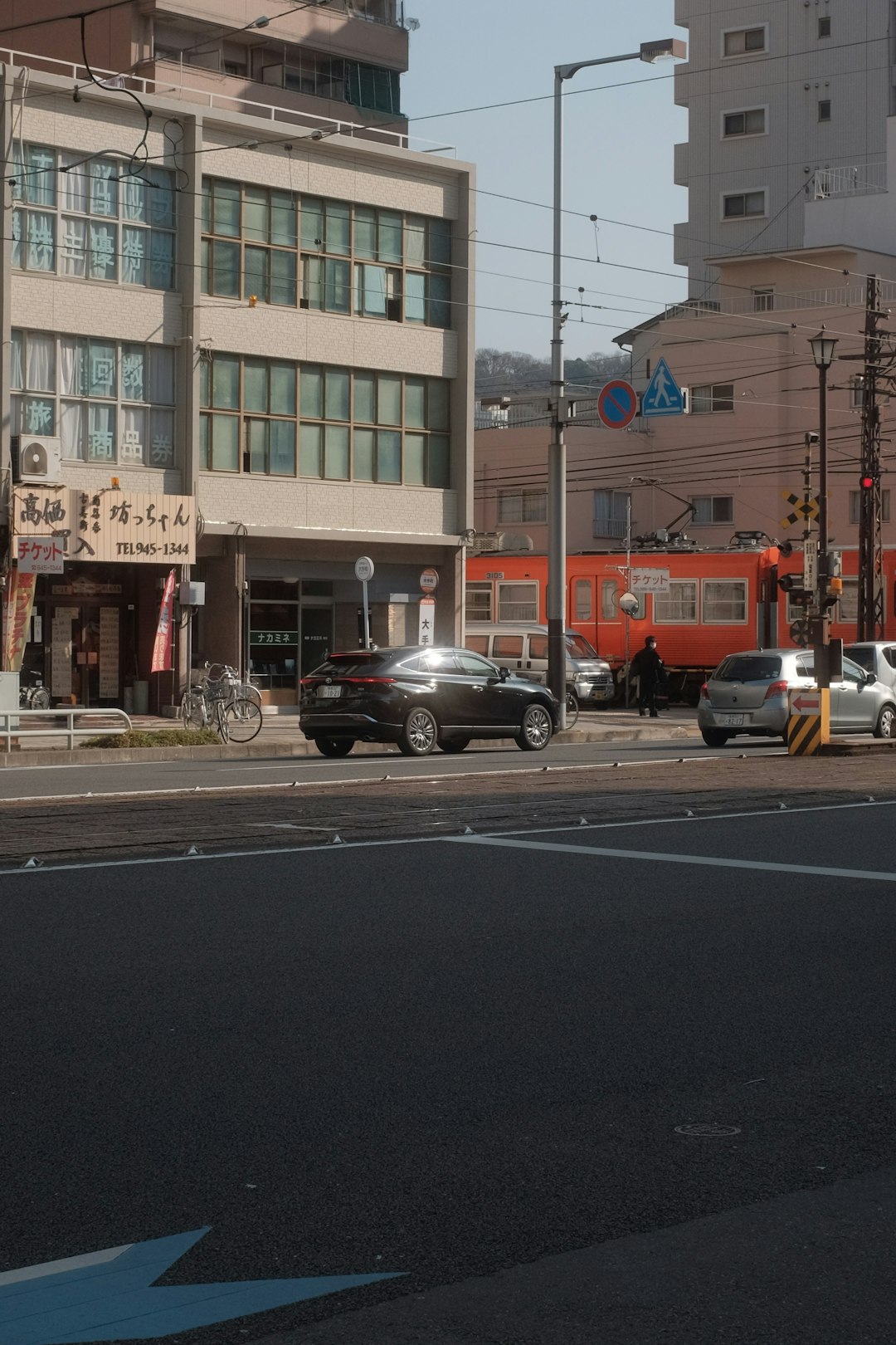 cars parked in front of brown building during daytime