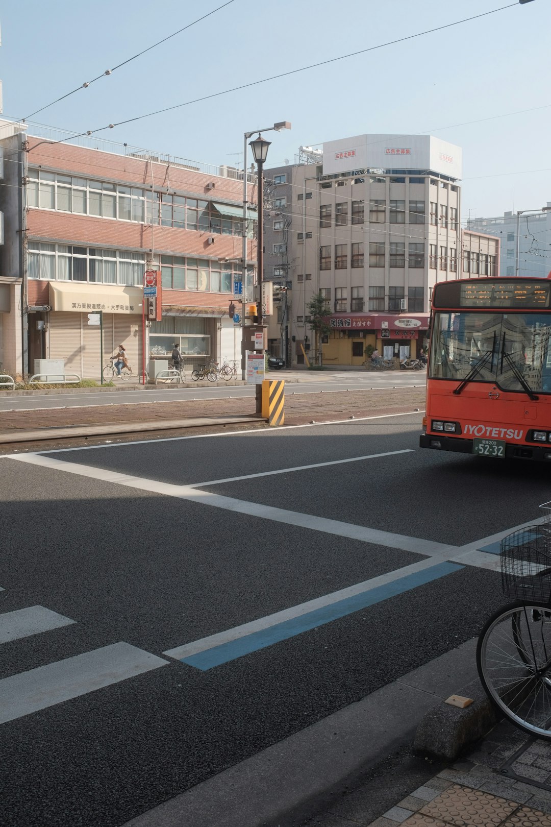 red bus on road near building during daytime